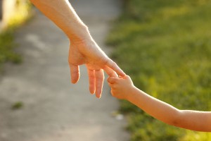 Taking the hand of a child